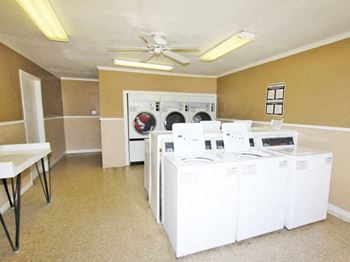 a room with a bunch of washers and dryers in it